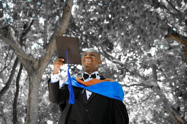 Man throwing his graduation cap in the air