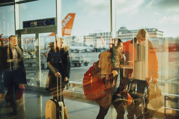 Travelers in line to board a plane