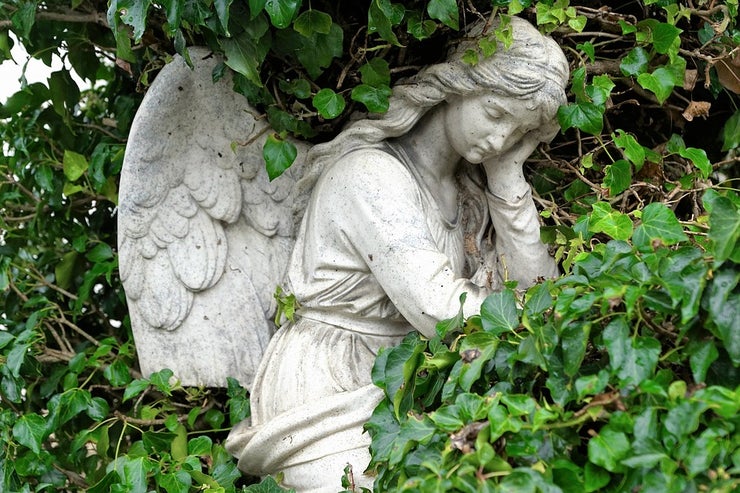 Stone angel surrounded by greenery