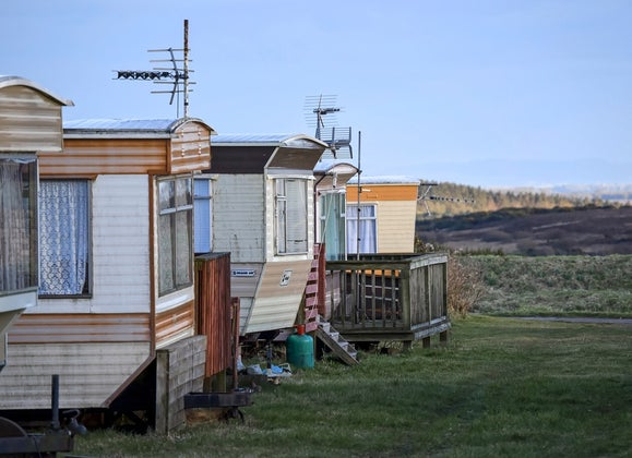Row of five single-wide mobile homes.