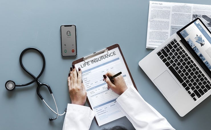 Person completing life insurance form.